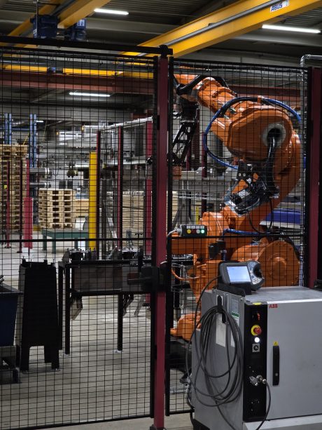 Den renoverade roboten i sin skyddade arbetscell, redo för automatiserad materialhantering.